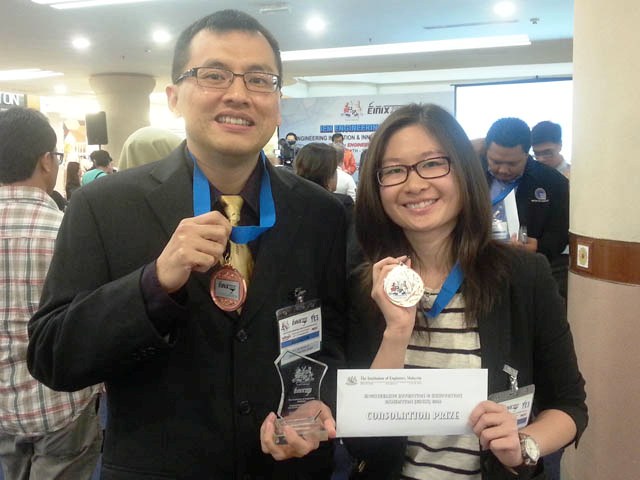 Dr Lim (left) and Wong smiling for the camera with their prize