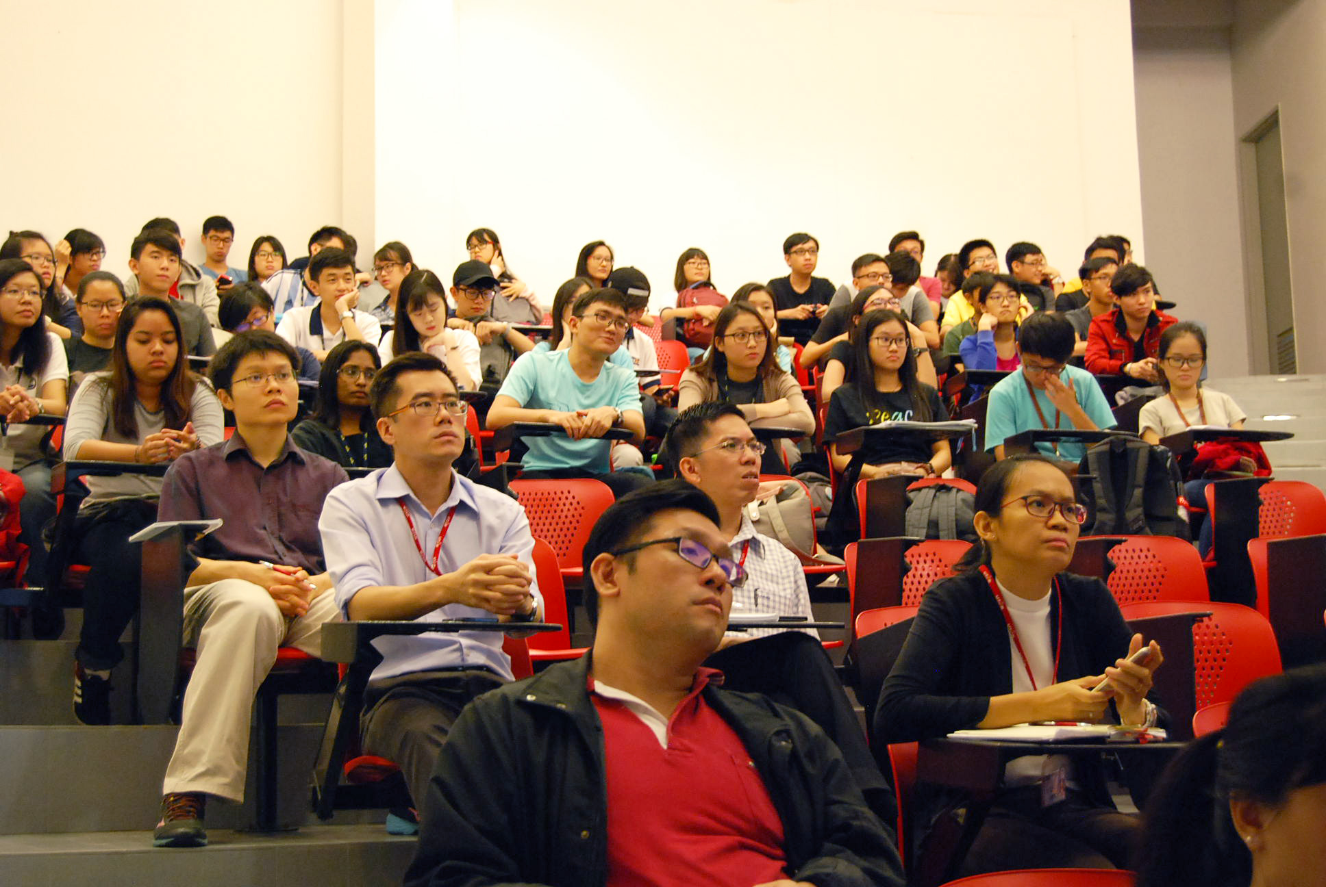 Staff and participants listening attentively to Stuart Soo